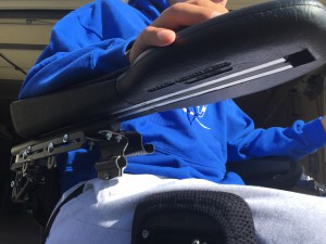 A view of the bottom of Jake's armrest where the storage compartment will attach to the chair.